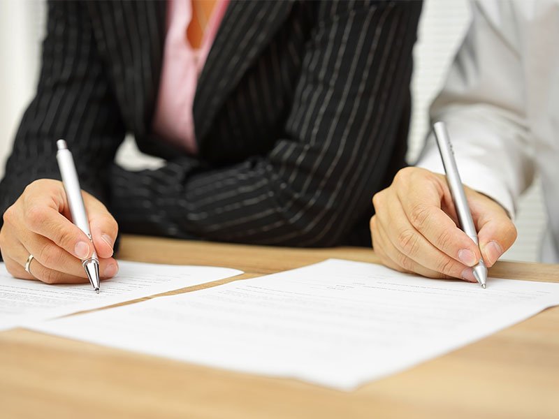 Woman & Man filling out an application form